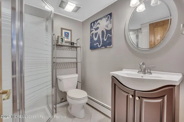 a bathroom with a toilet a sink and a mirror