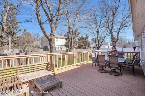 a view of a deck with table and chairs and wooden floor