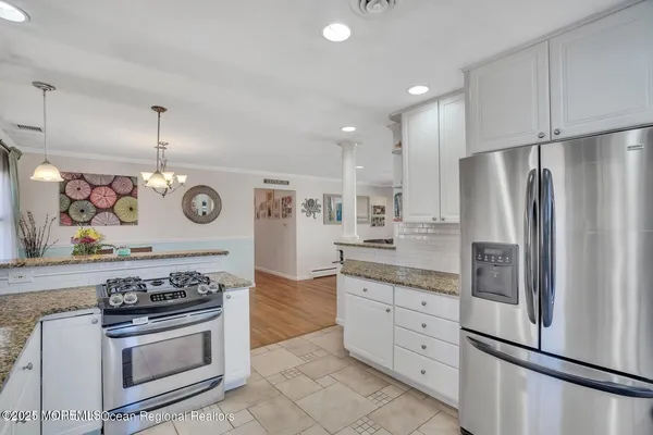 a kitchen with stainless steel appliances granite countertop a stove and a refrigerator