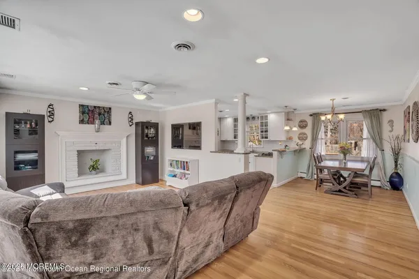 a living room with furniture and a dining table with kitchen view