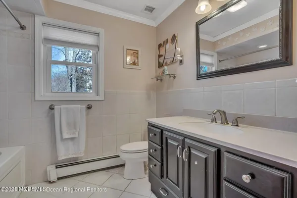 a bathroom with a sink a toilet and mirror