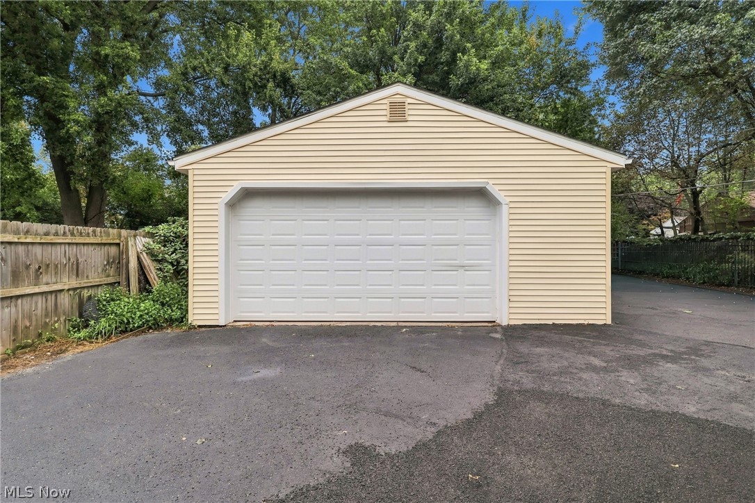 1875 Perth Road Madison, OH 44057 - Photo 4 of 48 Detached garage with horizontal siding, a single panel garage door, and an asphalt driveway