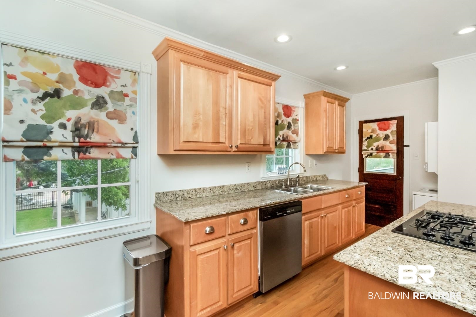 214 Upham Street, Unit 3D Mobile, AL 36607 - Photo 13 of 34 Kitchen featuring light stone countertops, stainless steel dishwasher, crown molding, light wood finish cabinetry, and light wood finished floors