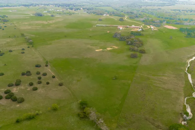 a view of a field with an ocean view