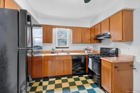 a kitchen with a stove sink and cabinets