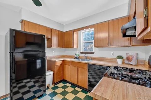 a kitchen with stainless steel appliances a stove a sink and a microwave