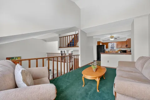 a living room with furniture a window and a bookshelf
