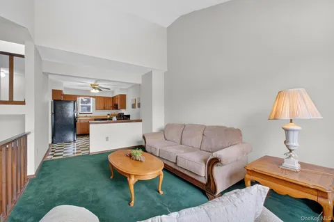 a living room with furniture a rug and a table