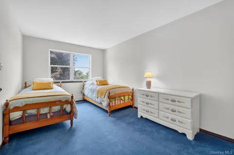 a bathroom with a sink a toilet a mirror and shower curtain