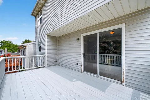 a balcony with wooden floor and fence