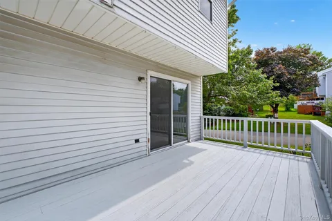 a view of a balcony with wooden floor