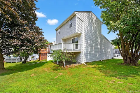 a house that has a tree in front of it