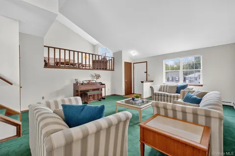 a living room with furniture fireplace and a window