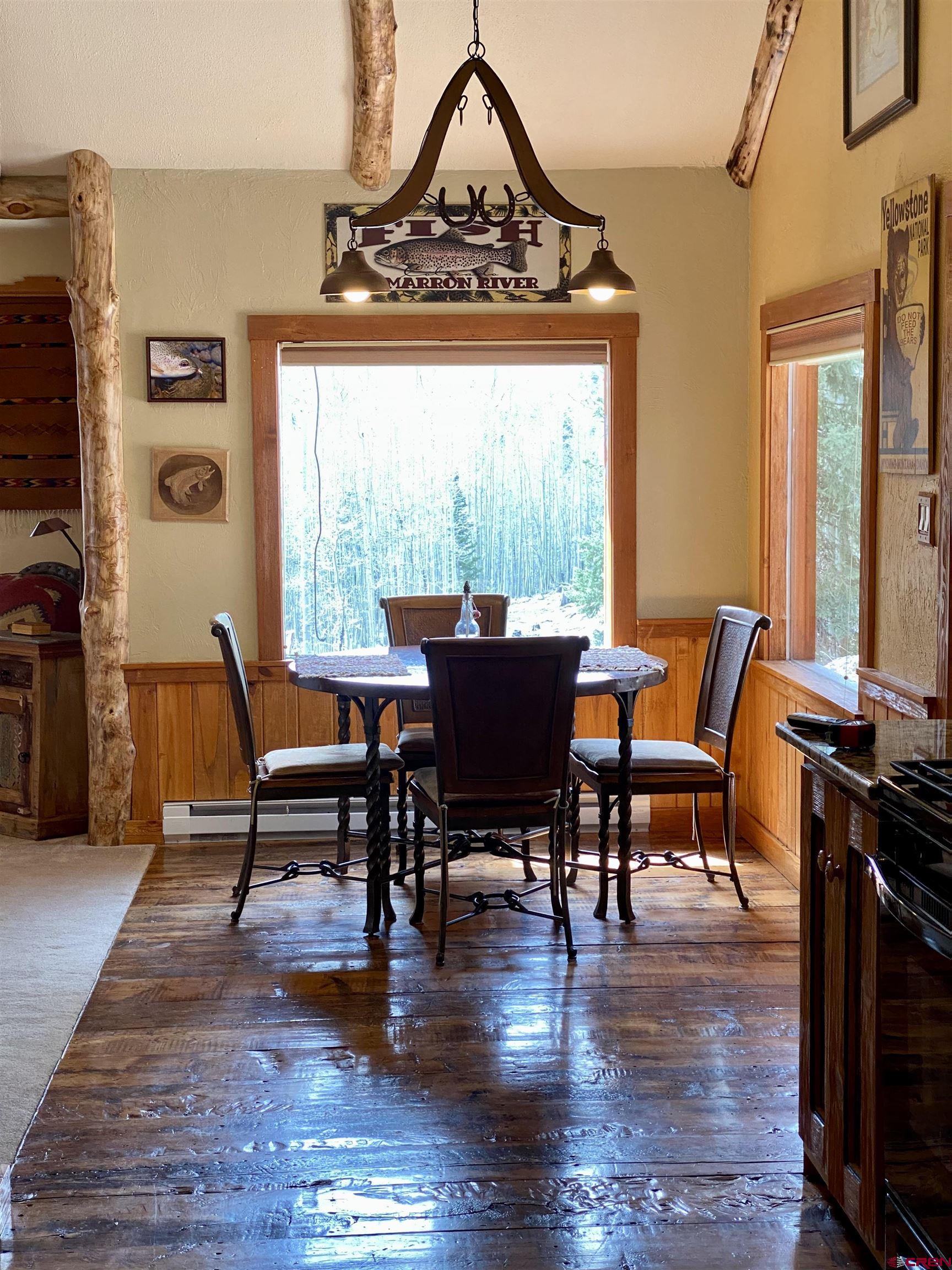480 Bear Trail Montrose, CO 81403 - Photo 11 of 35 a view of a dining room with furniture window and wooden floor
