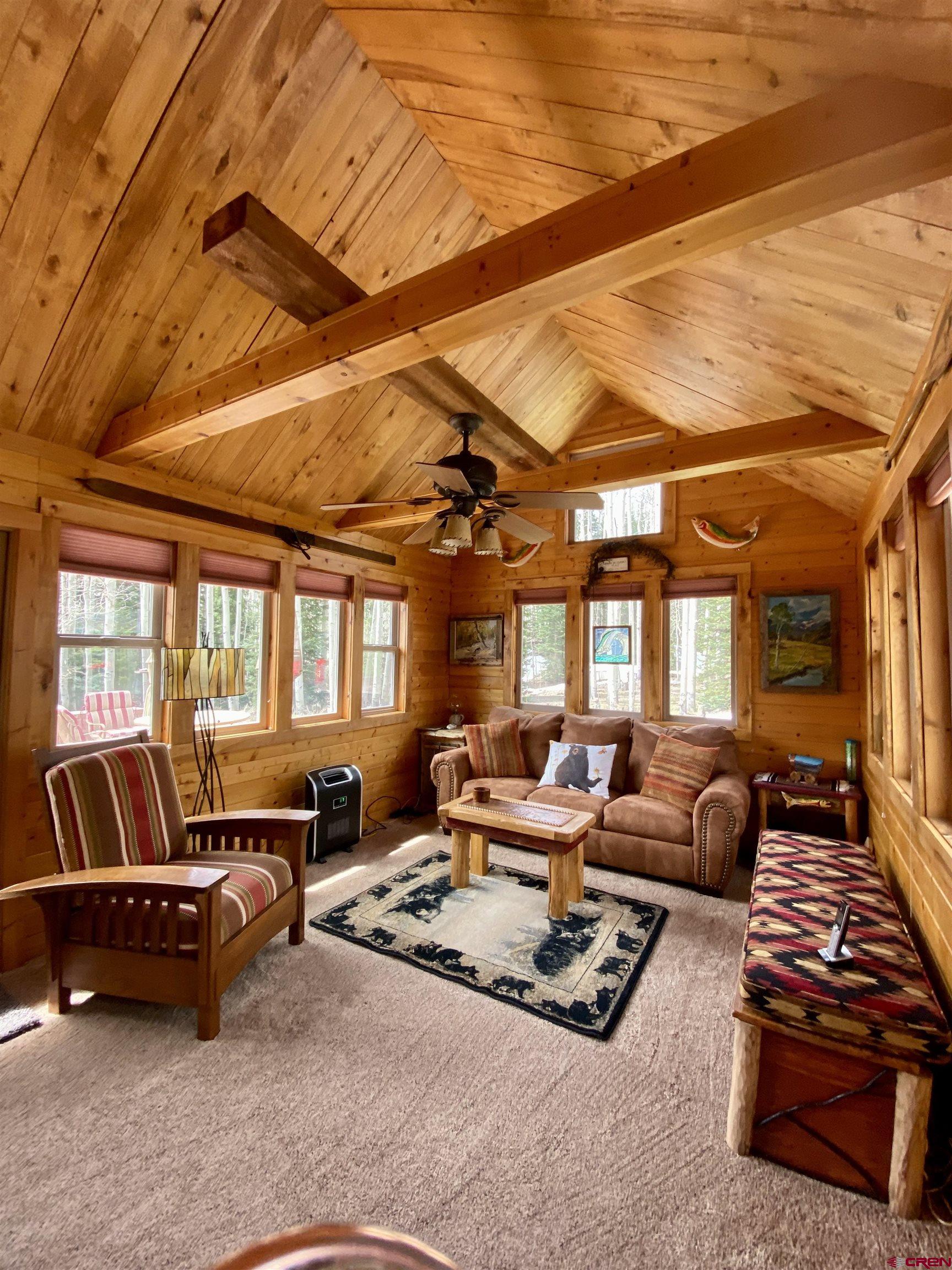 480 Bear Trail Montrose, CO 81403 - Photo 14 of 35 a living room with furniture ceiling fan and a rug
