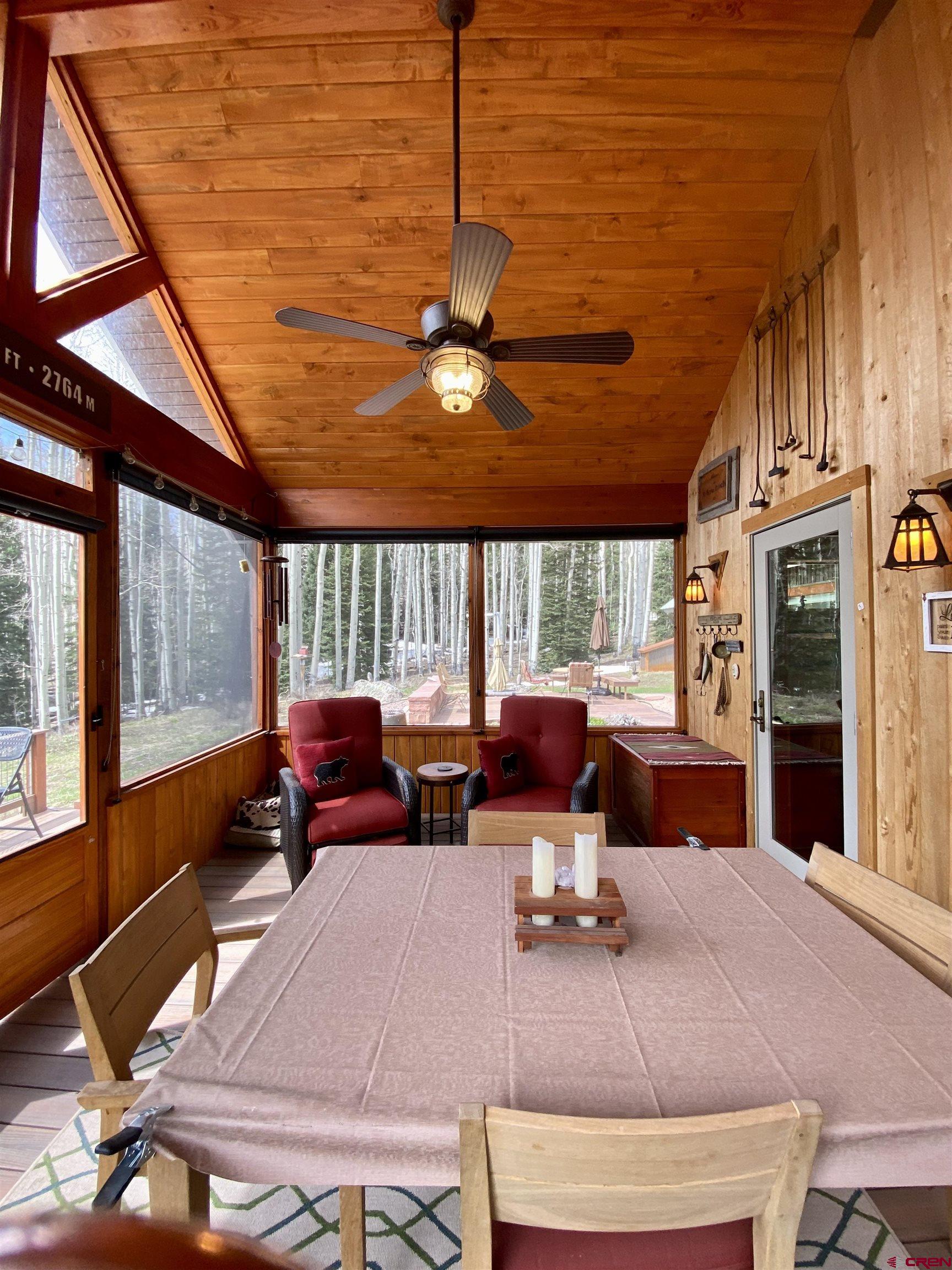 480 Bear Trail Montrose, CO 81403 - Photo 24 of 35 a living room with furniture a large window and a chandelier