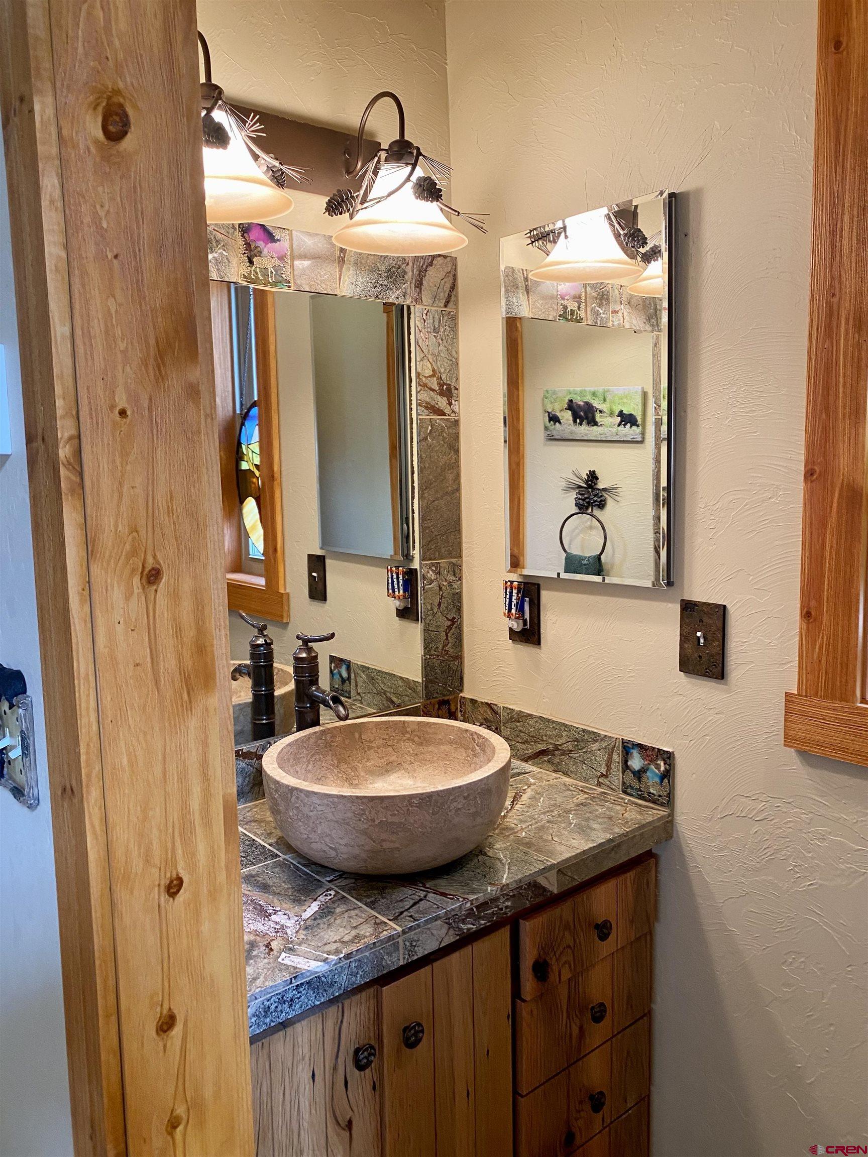 480 Bear Trail Montrose, CO 81403 - Photo 27 of 35 a bathroom with a granite countertop sink and a mirror