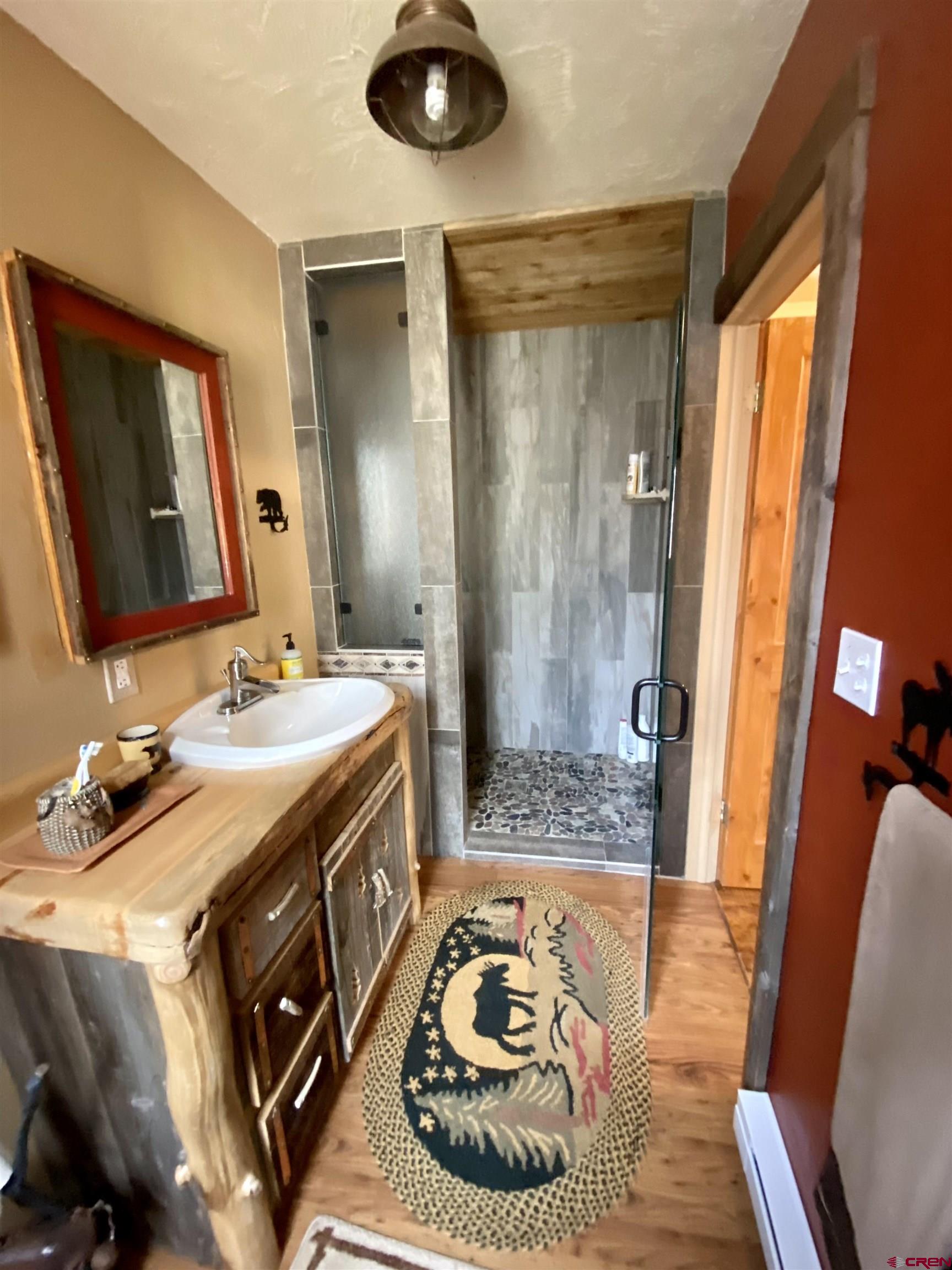 480 Bear Trail Montrose, CO 81403 - Photo 28 of 35 a bathroom with a sink a mirror and a shower