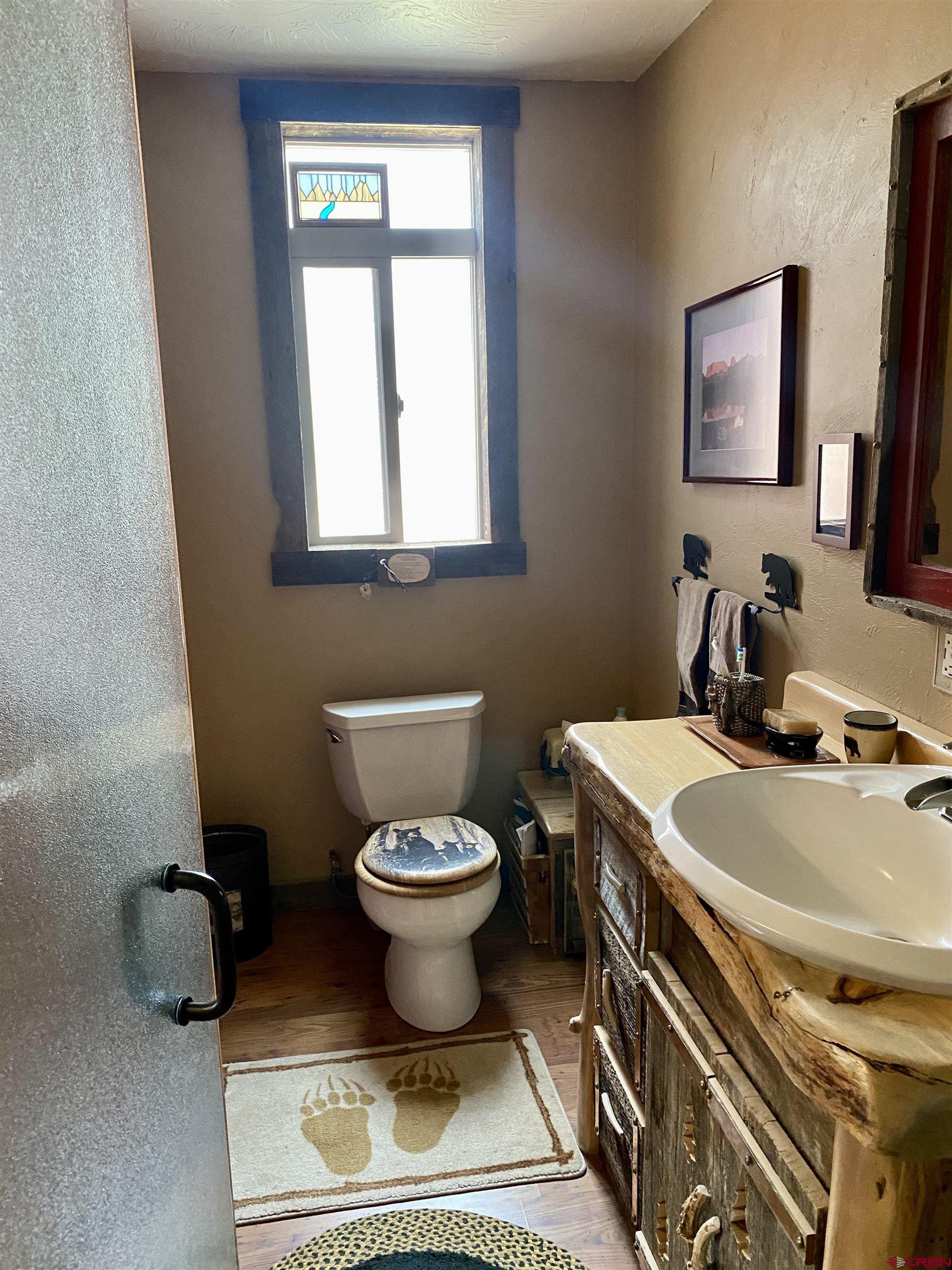 480 Bear Trail Montrose, CO 81403 - Photo 29 of 35 a bathroom with a toilet sink and mirror