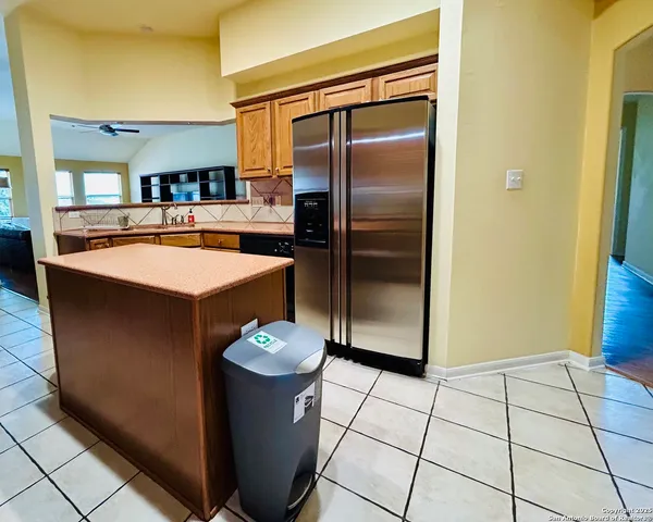 a kitchen with stainless steel appliances a stove a sink a microwave a refrigerator and cabinets