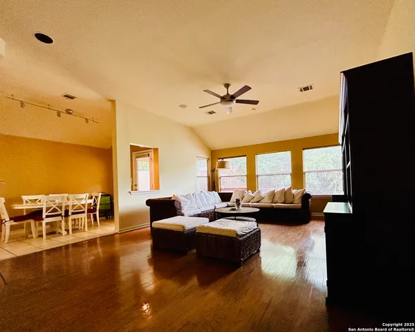 a living room with a bed furniture and a window