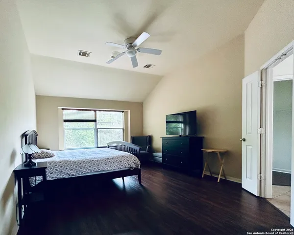 a bedroom with furniture and a window
