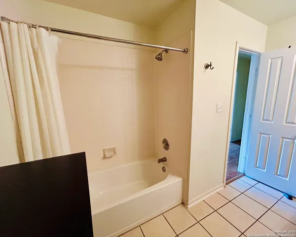 a bathroom with a granite countertop sink toilet and mirror