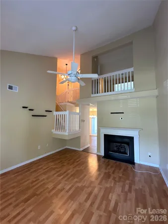 a view of an empty room with a fireplace and a window