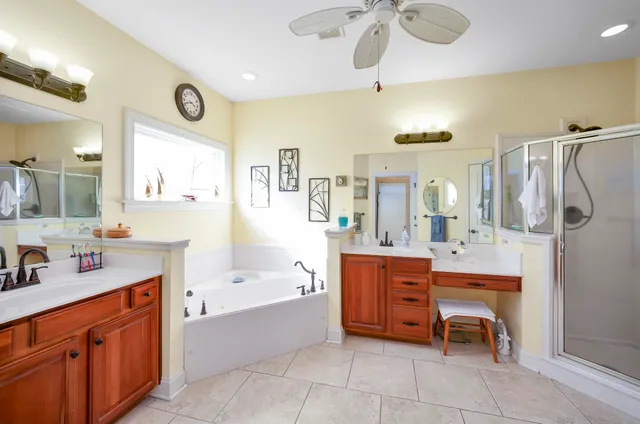 a bathroom with a tub sink and mirror