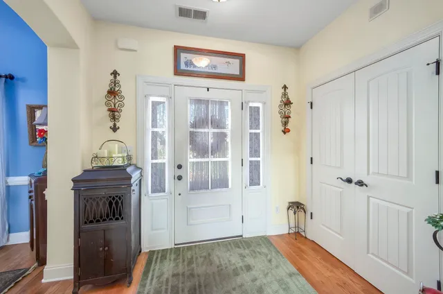 a view of a hallway with entryway wooden floor and front door