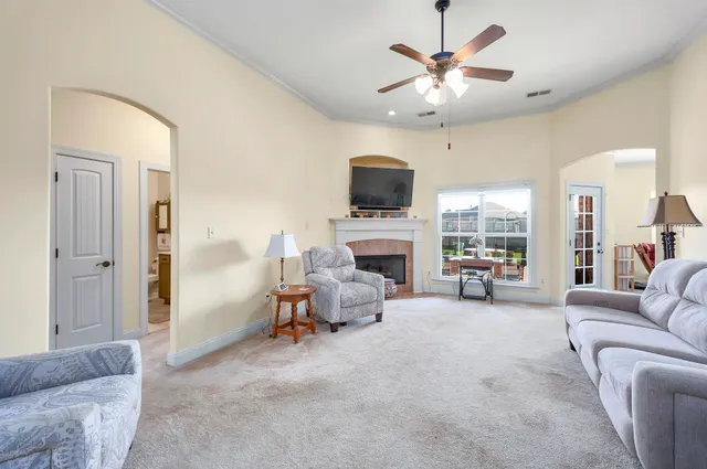 a living room with furniture a fireplace and a flat screen tv