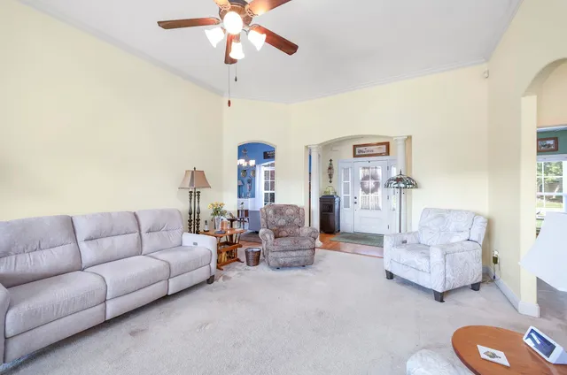 a living room with furniture and a chandelier