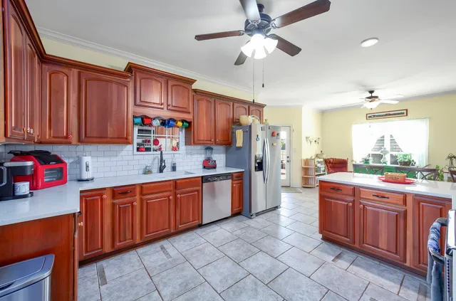 a kitchen with stainless steel appliances granite countertop a sink dishwasher stove top oven and cabinets