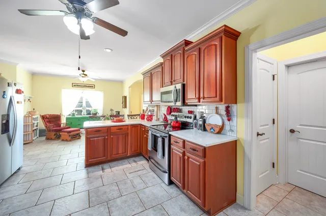 a kitchen with stainless steel appliances granite countertop a sink counter space cabinets and a window