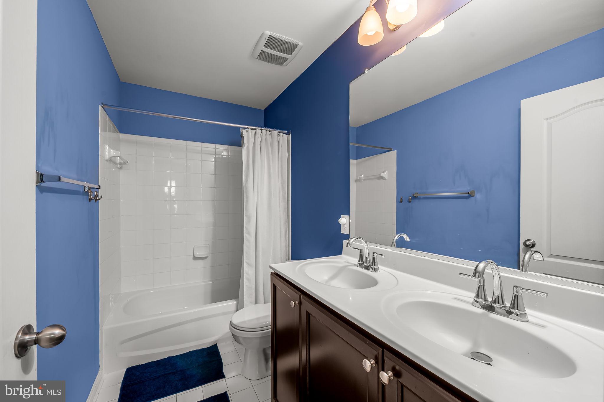 6008 Hanover Road Elkridge, MD 21075 - Photo 27 of 36 a bathroom with a granite countertop sink toilet and shower