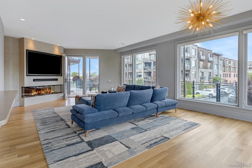 18 Rivers Edge Drive, Unit 211 Tarrytown, NY 10591 - Photo 6 of 30 a living room with furniture and a flat screen tv