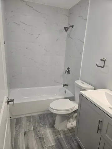 a bathroom with a sink toilet and shower