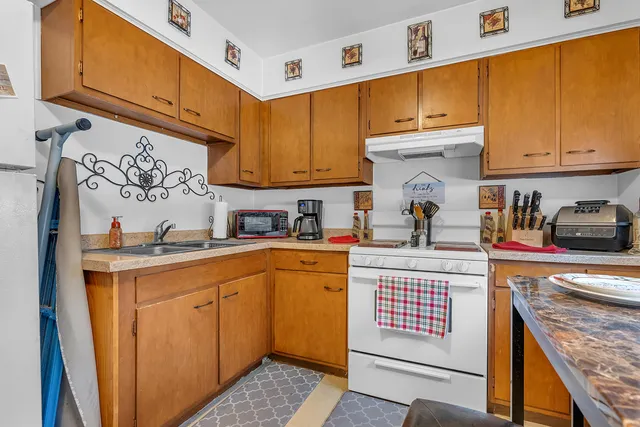 a kitchen with stainless steel appliances granite countertop a sink and cabinets