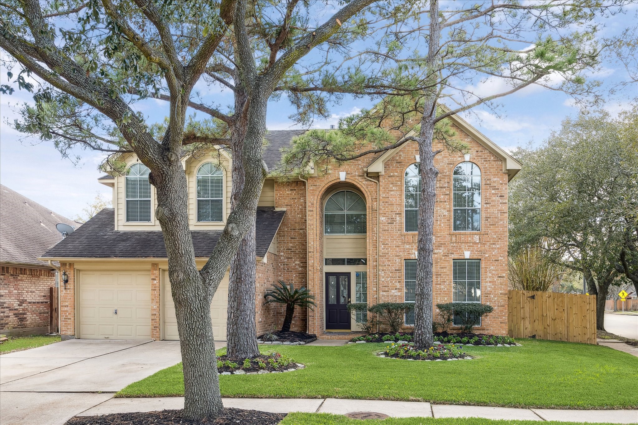 12831 Dove Point Lane Houston, TX 77041 - Photo 4 of 50 a front view of a house with a yard and an tree