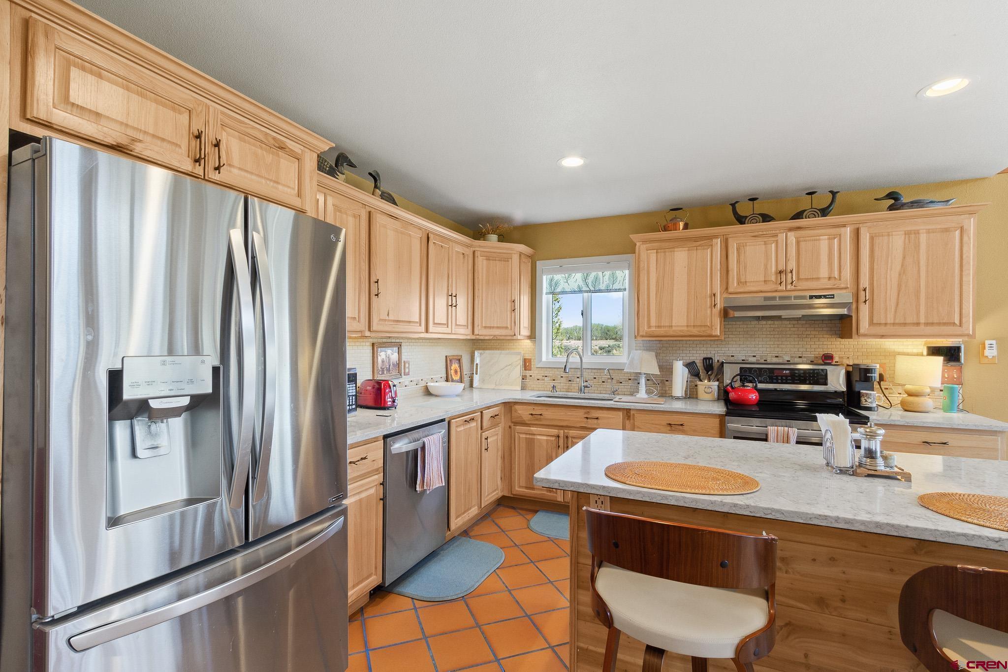 13720 6000th Road Montrose, CO 81403 - Photo 13 of 36 a kitchen with stainless steel appliances a refrigerator sink and cabinets