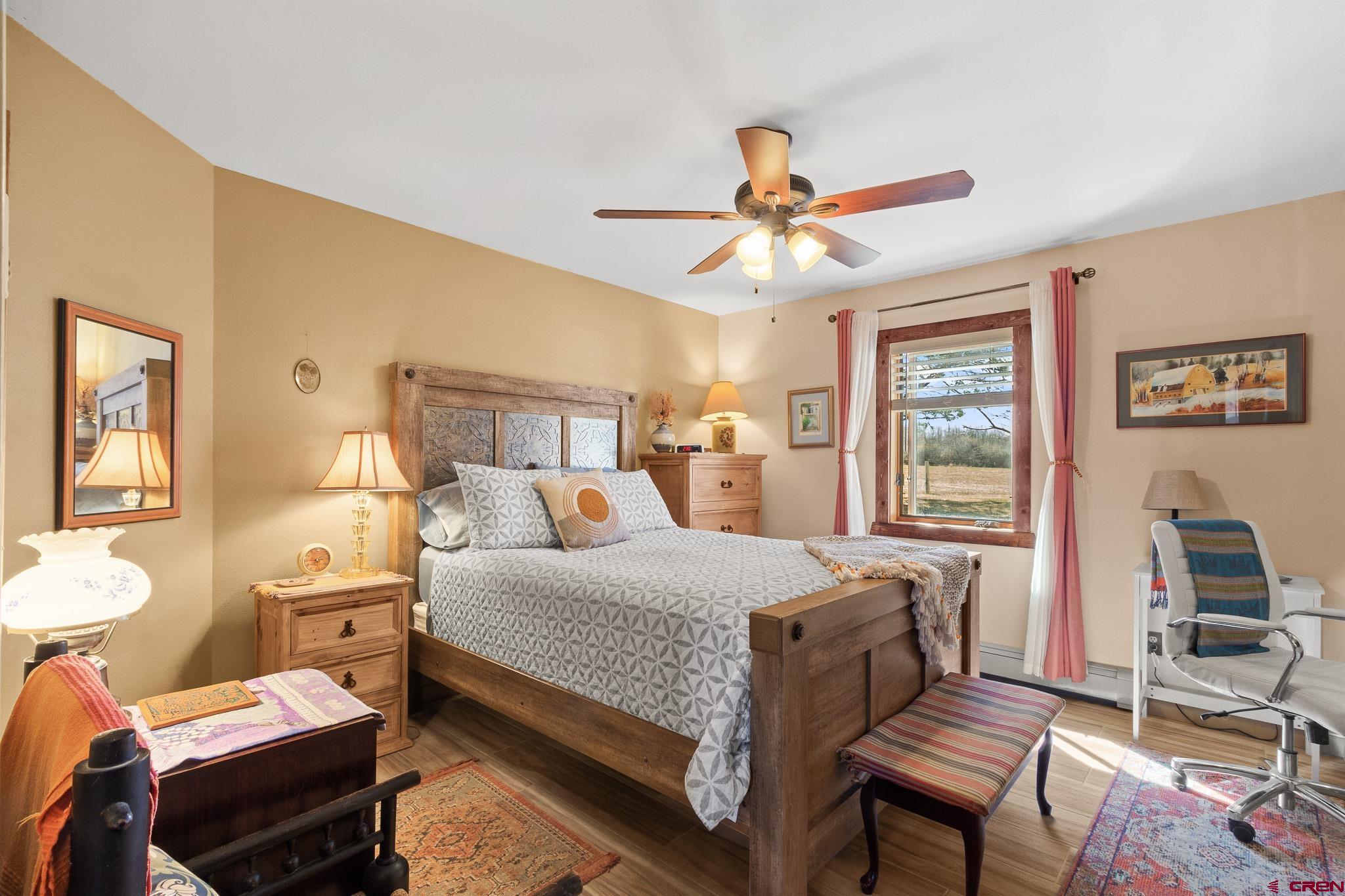 13720 6000th Road Montrose, CO 81403 - Photo 15 of 36 a bedroom with a bed and wooden floor