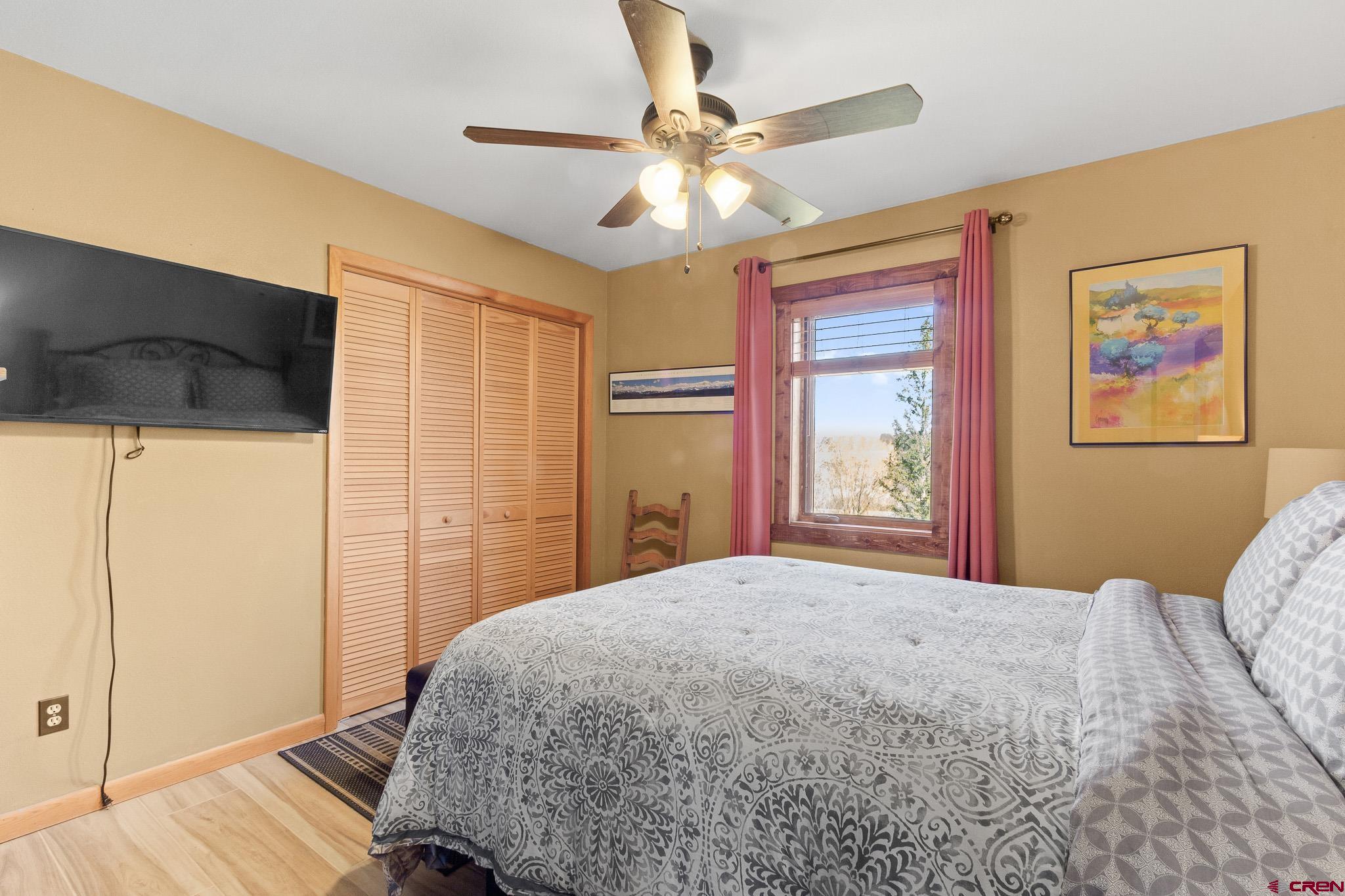 13720 6000th Road Montrose, CO 81403 - Photo 17 of 36 a bedroom with a large bed and a chandelier