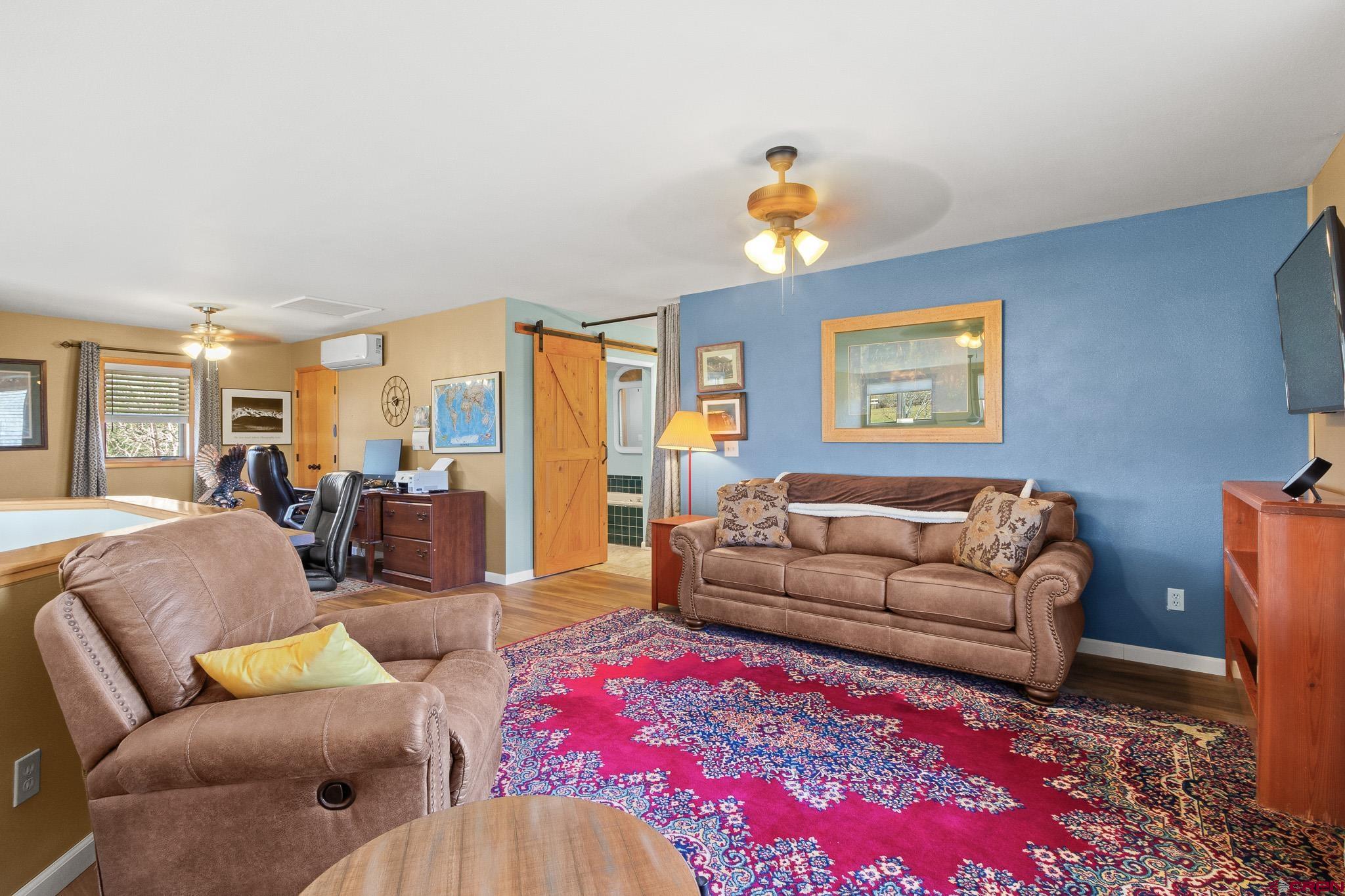 13720 6000th Road Montrose, CO 81403 - Photo 19 of 36 a living room with furniture dining area and a chandelier
