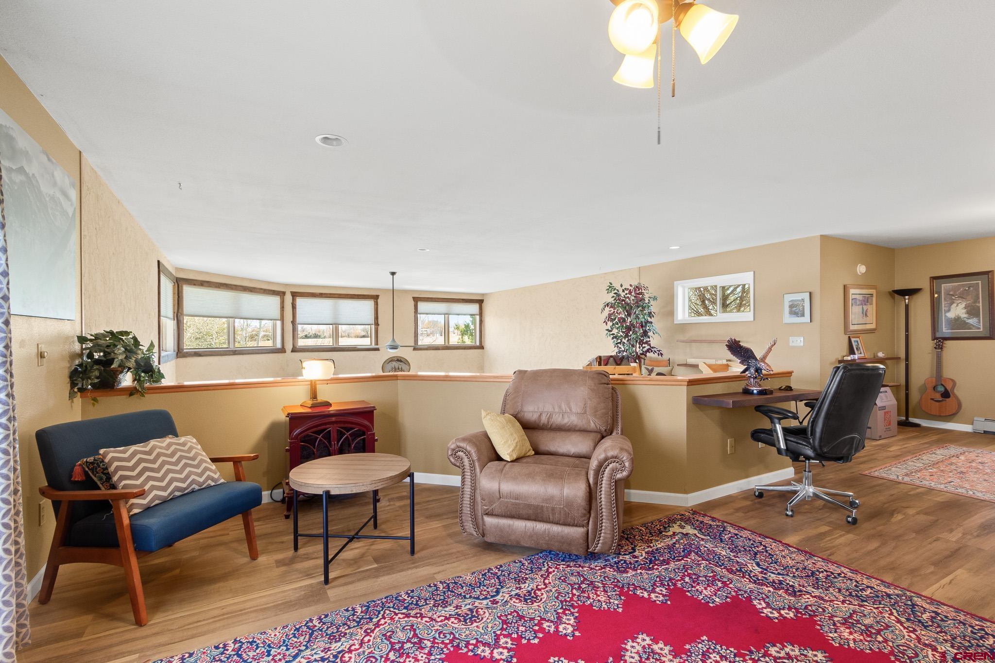 13720 6000th Road Montrose, CO 81403 - Photo 20 of 36 a living room with furniture a rug and a table