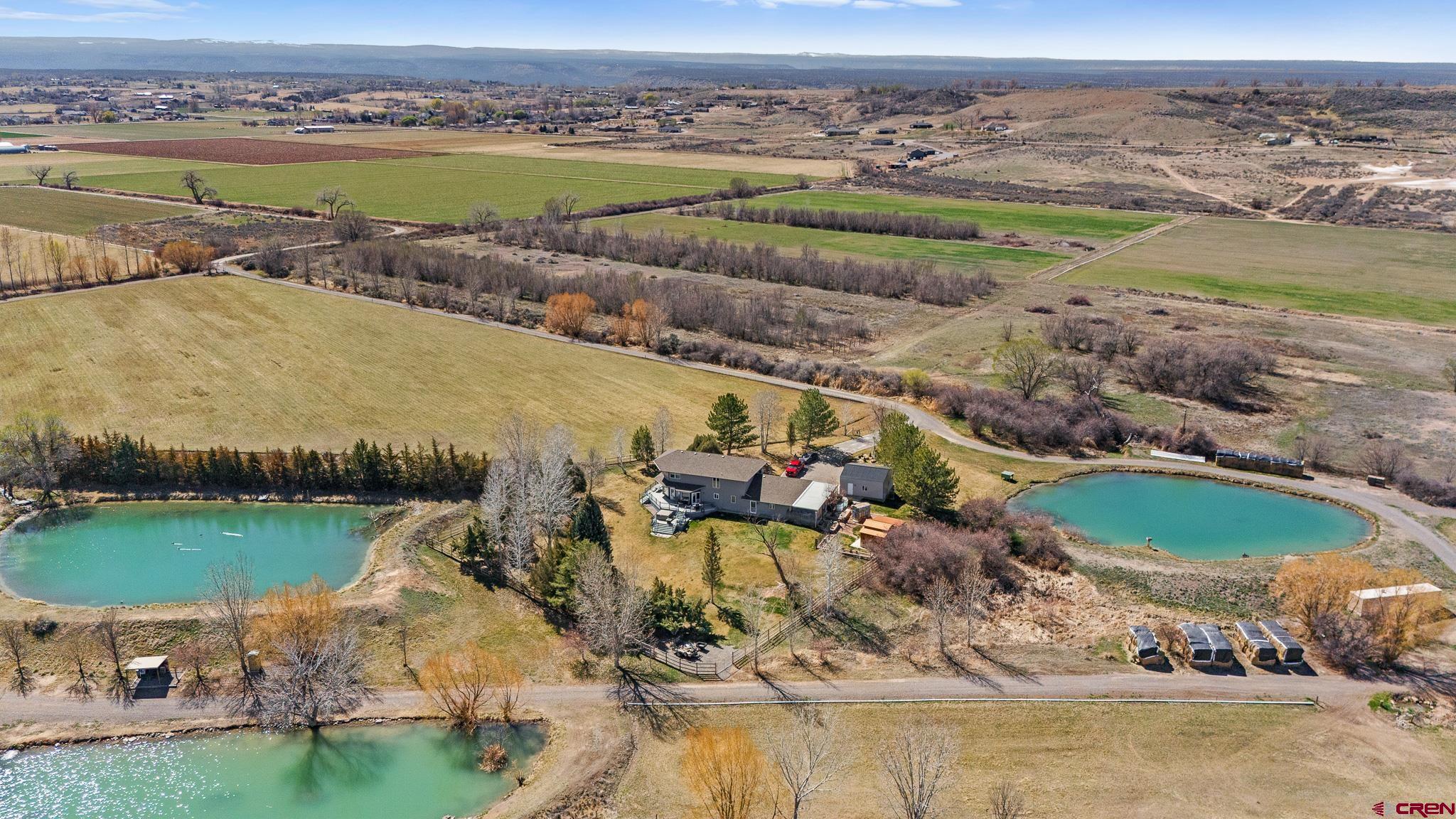 13720 6000th Road Montrose, CO 81403 - Photo 2 of 36 an aerial view of a house with a lake view