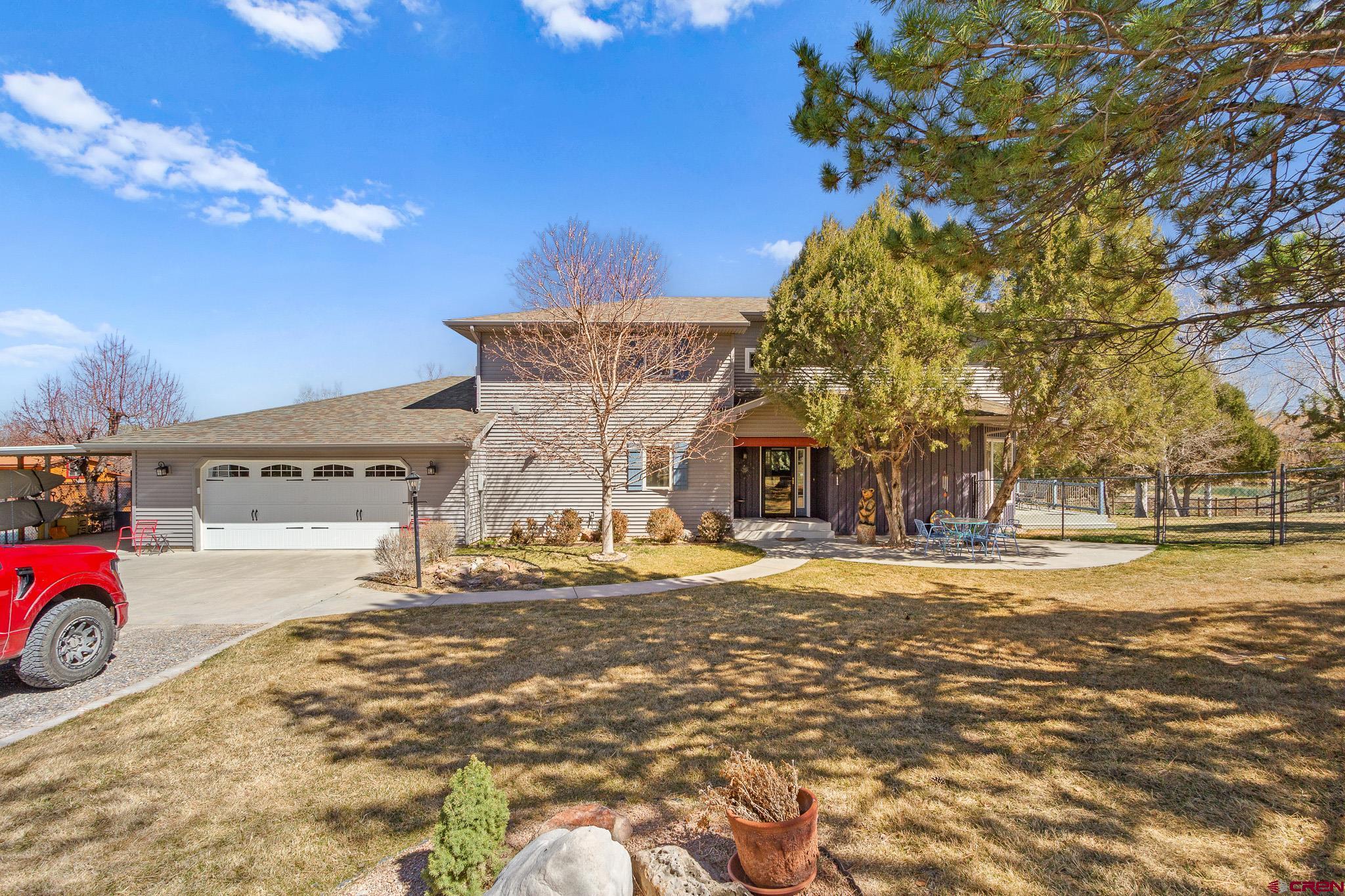 13720 6000th Road Montrose, CO 81403 - Photo 5 of 36 a front view of a house with a yard