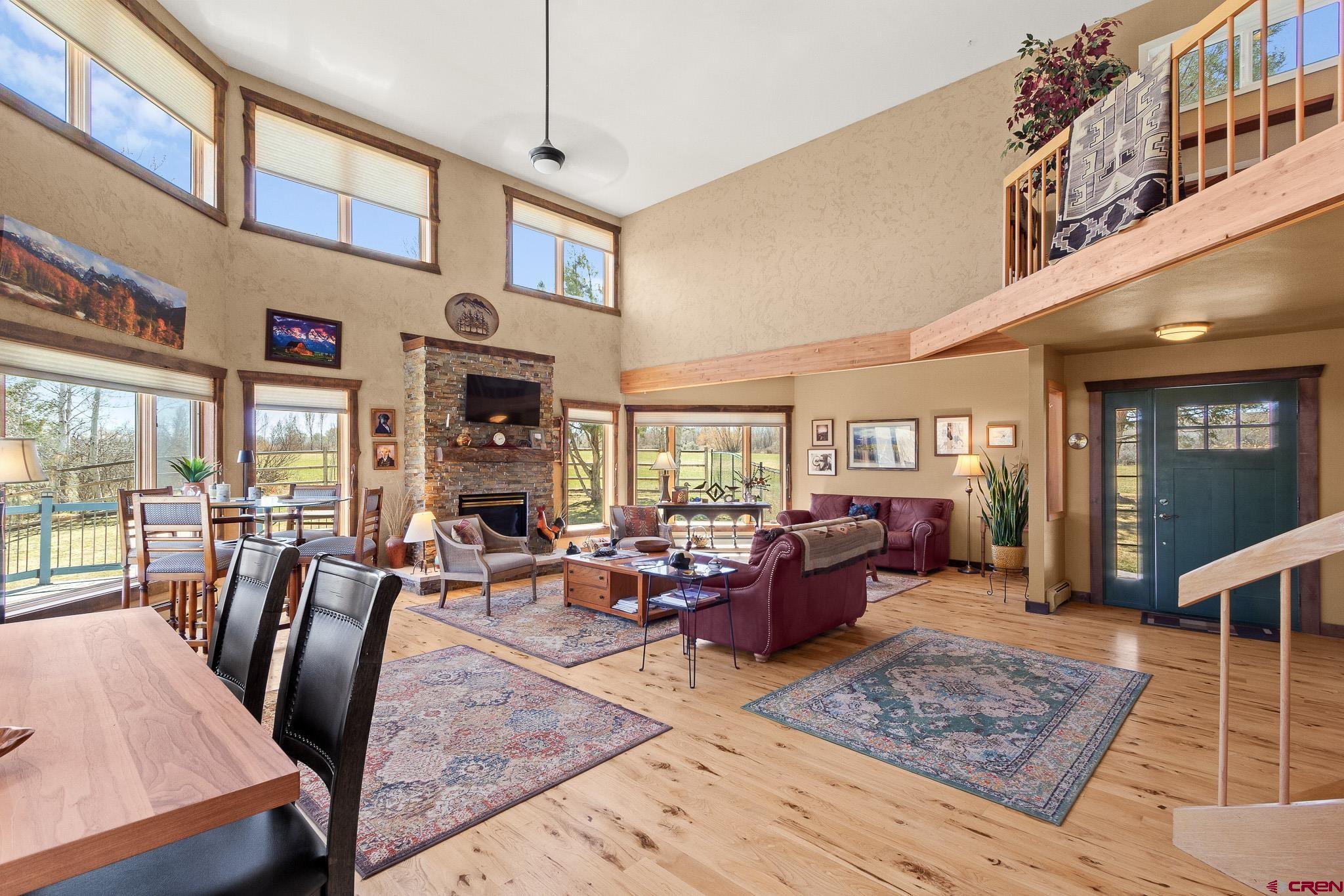 13720 6000th Road Montrose, CO 81403 - Photo 8 of 36 a living room with fireplace furniture rug and a large window