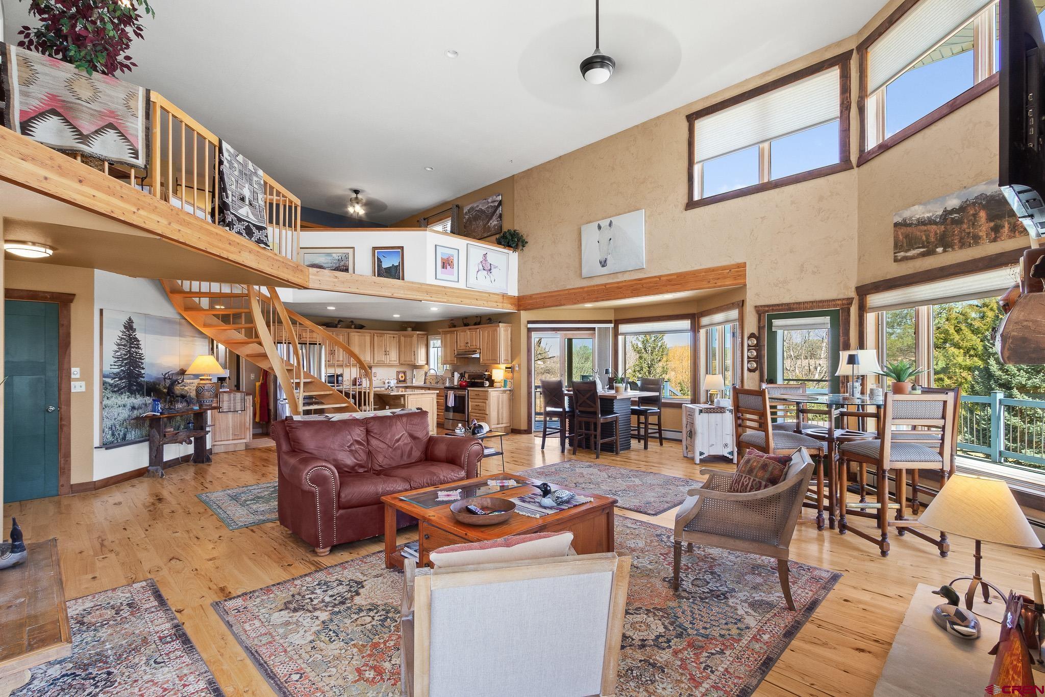 13720 6000th Road Montrose, CO 81403 - Photo 10 of 36 a living room with lots of furniture windows and a rug