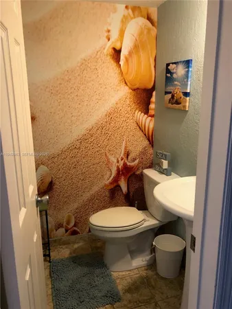 a kitchen with stainless steel appliances wooden cabinets a sink and a stove