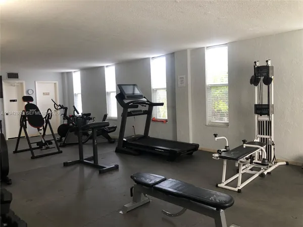 a kitchen with a sink a stove and chairs